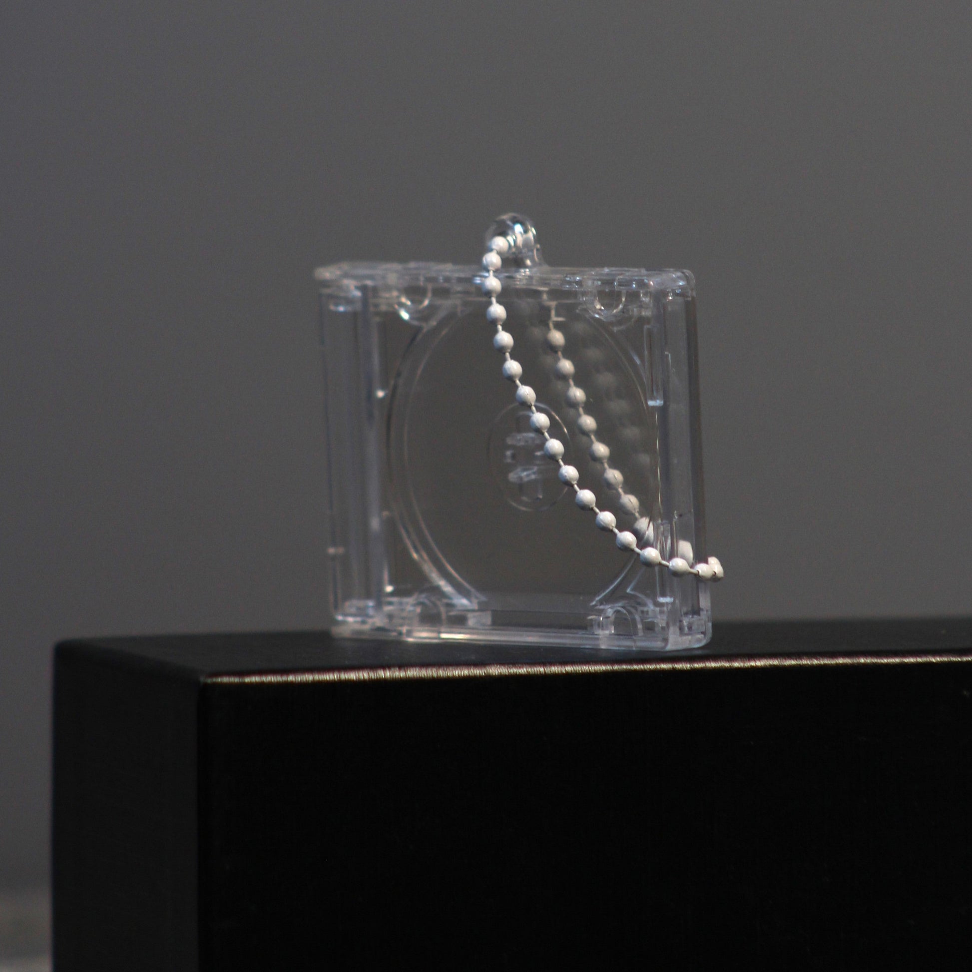 closed case with ball chain hanging