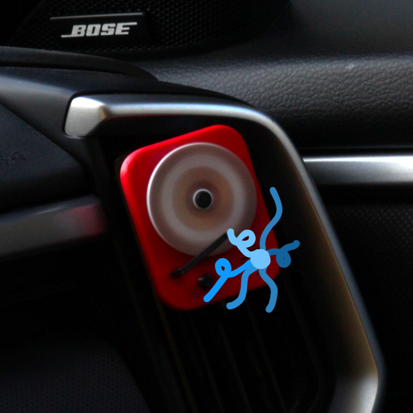 Air freshener placed on car air vent in action